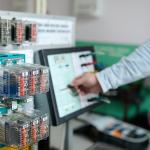 Na zdjęciu ręka, komputer i urządzenia z laboratorium