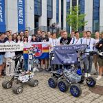 Na zdjęciu grupa studentów z dwoma łazikami marsjańskimi